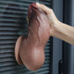 The 7 inches fat silicone butt plug dildo is firmly attached to the wall with its suction cup 