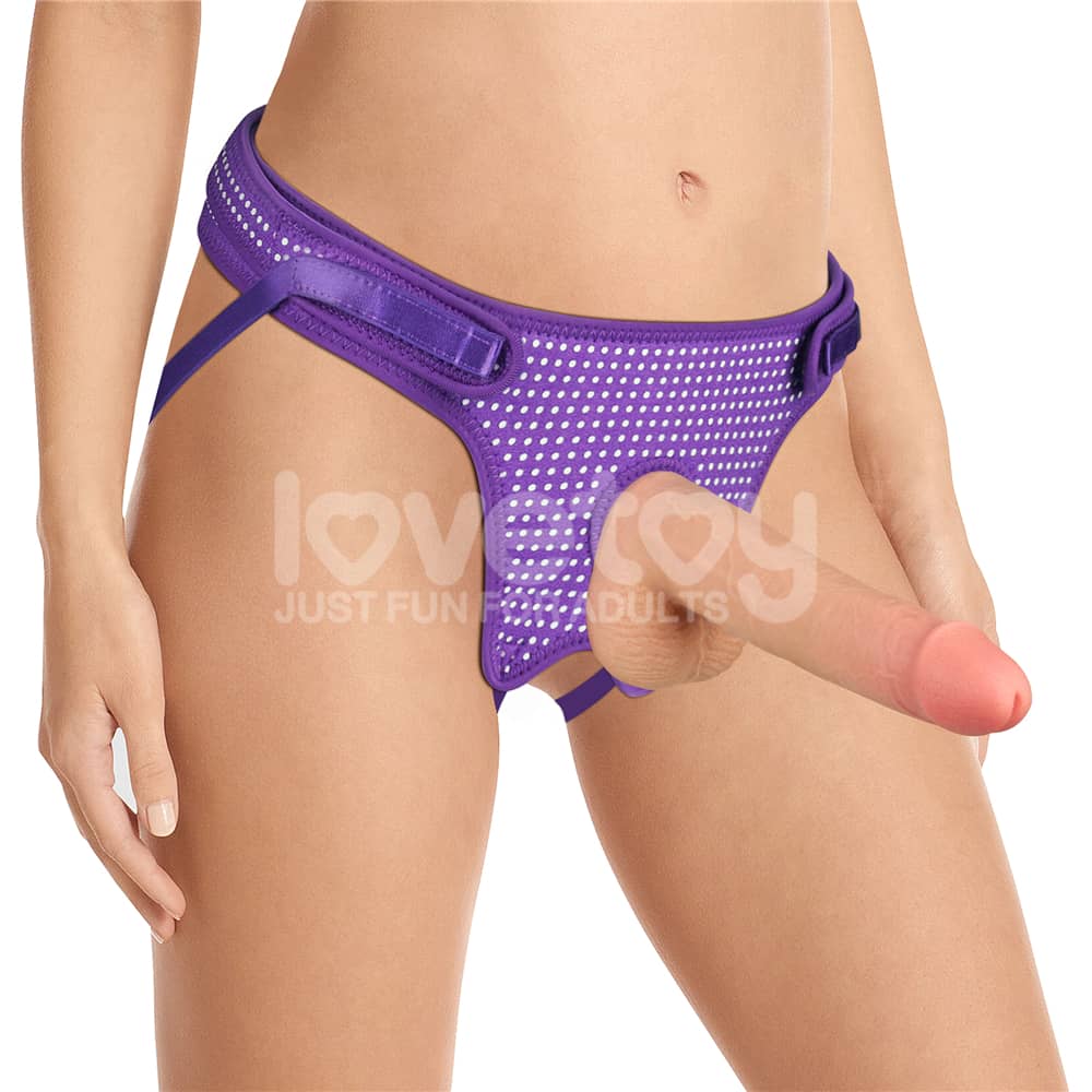 A woman wears the easy strap on harness polka dots purple with a dildo