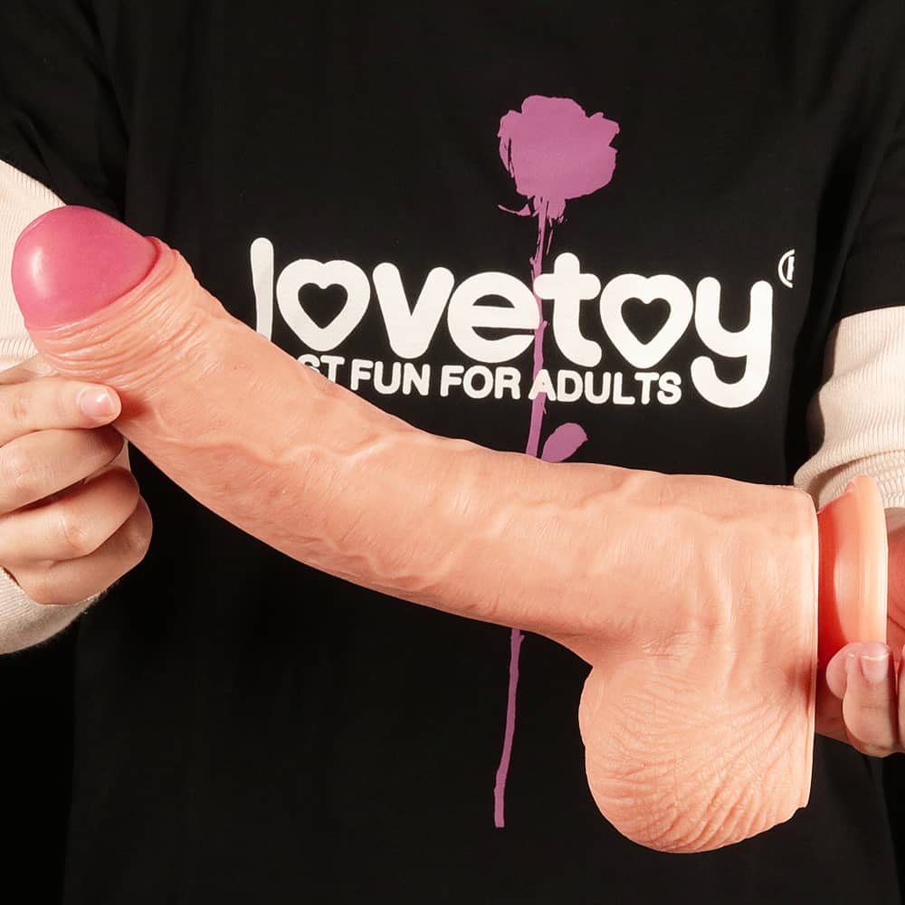 A man holds the 11 inches dual layer platinum silicone cock