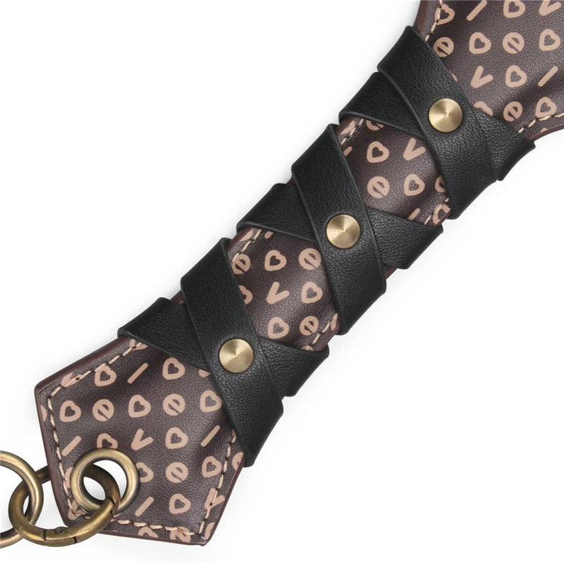 The handle of the 15 inches rebellion reign love paddle has antique bronze spikes elements