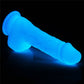 The 7.5 inches lumino play silicone dildo lays flat emitting blue fluorescence 