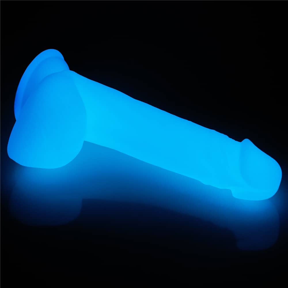 The 8 inches lumino play silicone dildo shows its back and balls 
