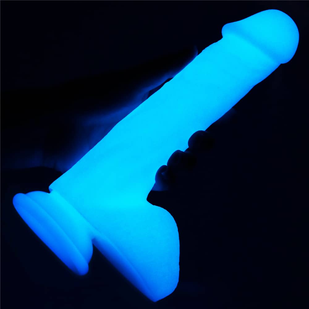 A man holds the 8 inches lumino play silicone dildo