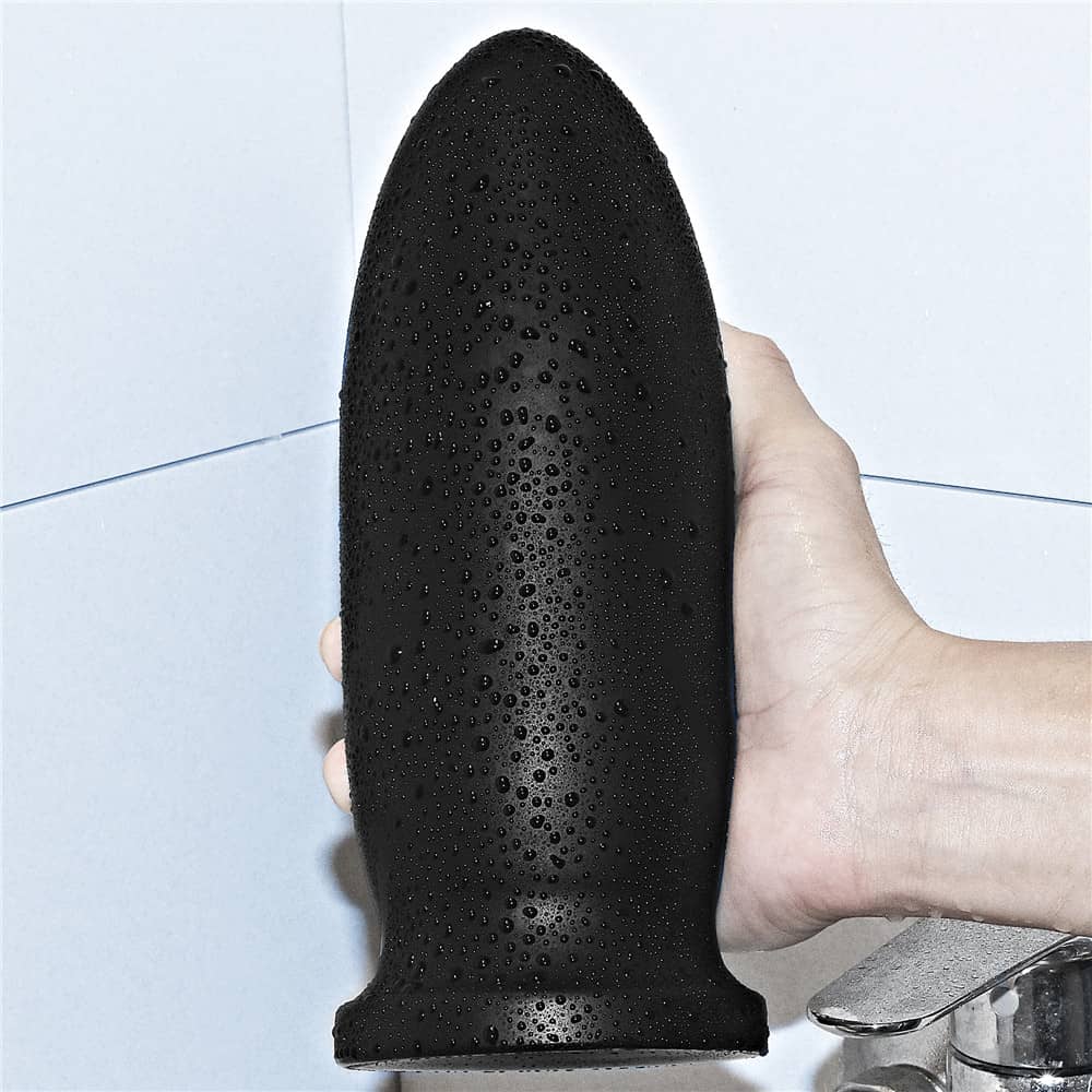 The 9" king size bomber butt plug is held in the hand