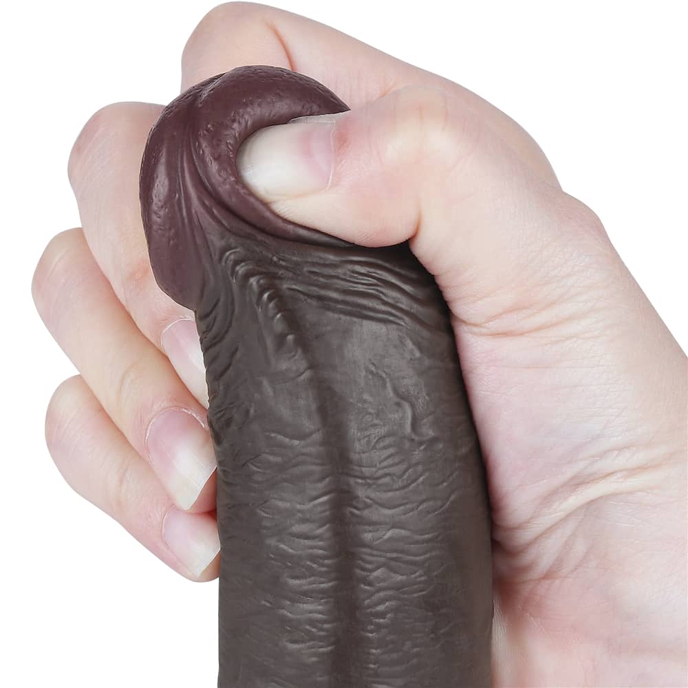 The bulging but soft head of the 9 inches black sliding skin dual layer dong 