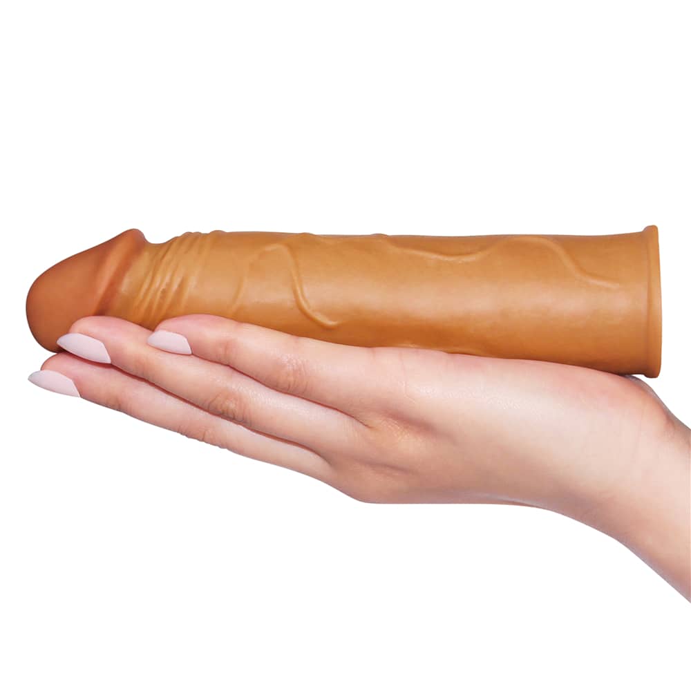 The add 1 inches pleasure x tender penis sleeve lays flat on the palm