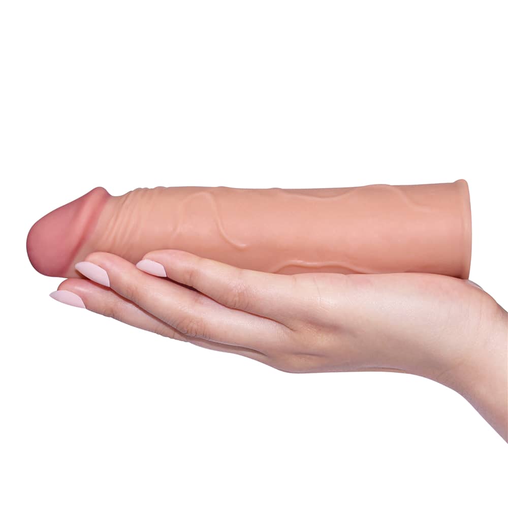 The add 1 inches pleasure x tender flesh penis sleeve lays flat on the palm