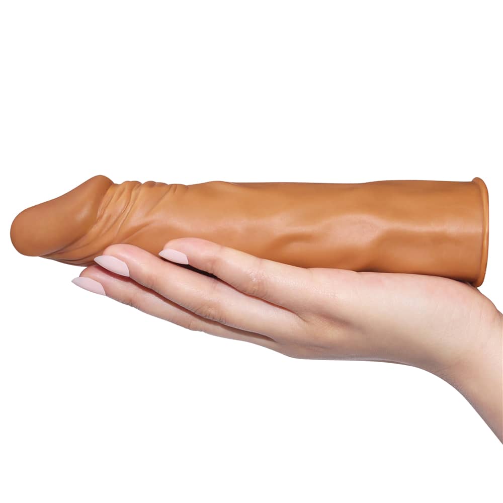 The brown add 2 inches x tender penis sleeve lays flat on the palm