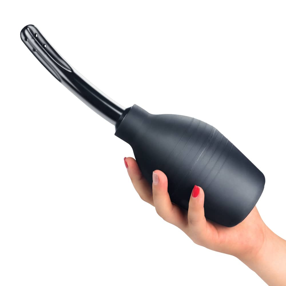A woman holds the anal cleaner douche bulb