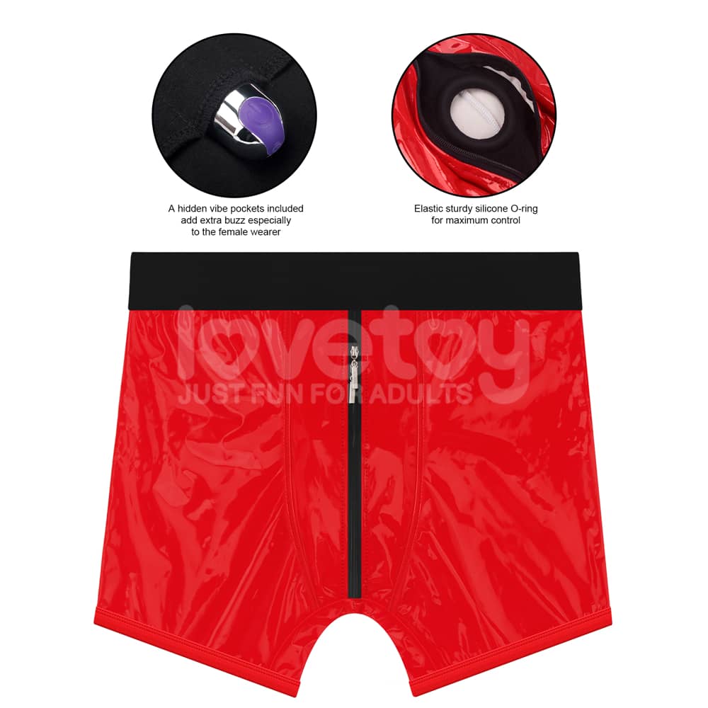 The mini vibrator is put in a hidden pocket at the bottom of the red chic strap on shorts 