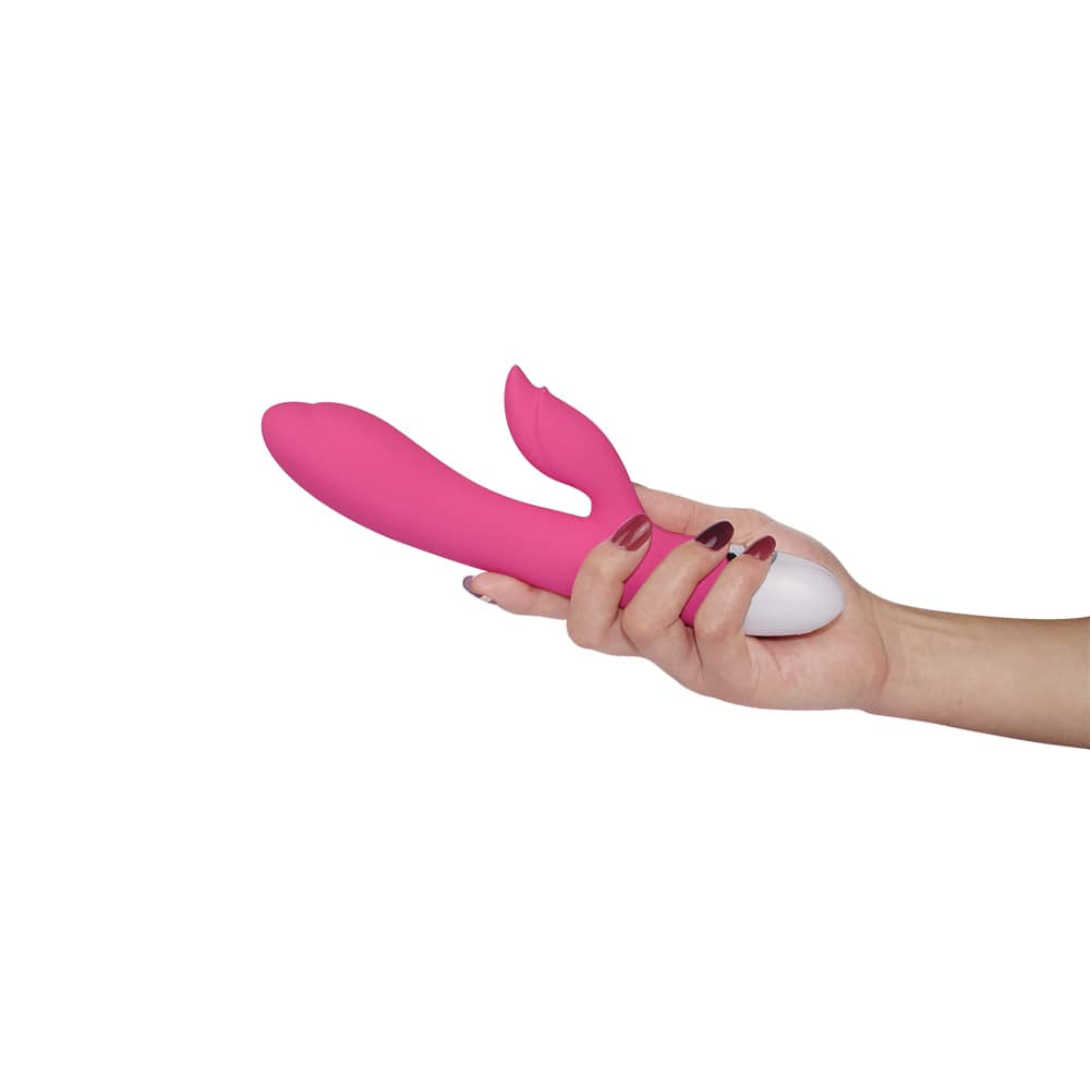 A woman holds the pink rechargeable vibrator