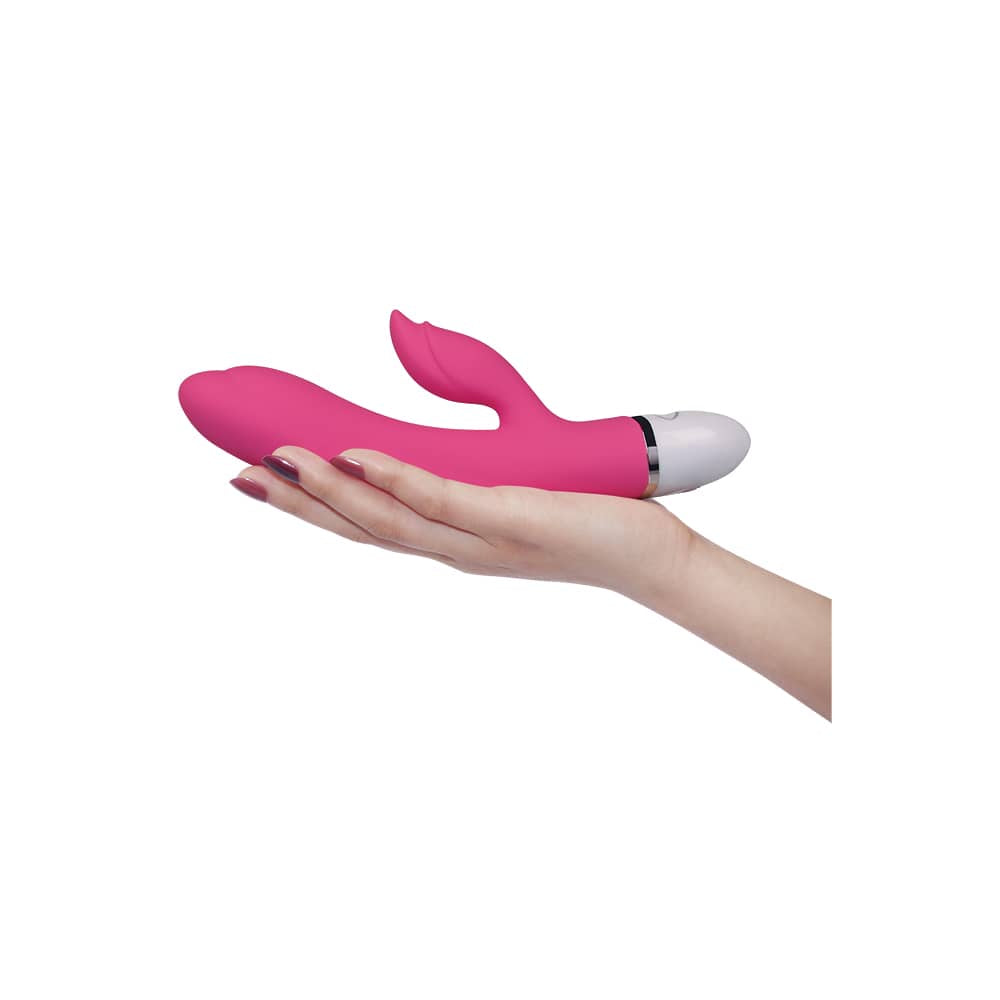 The pink rechargeable vibrator is on the palm