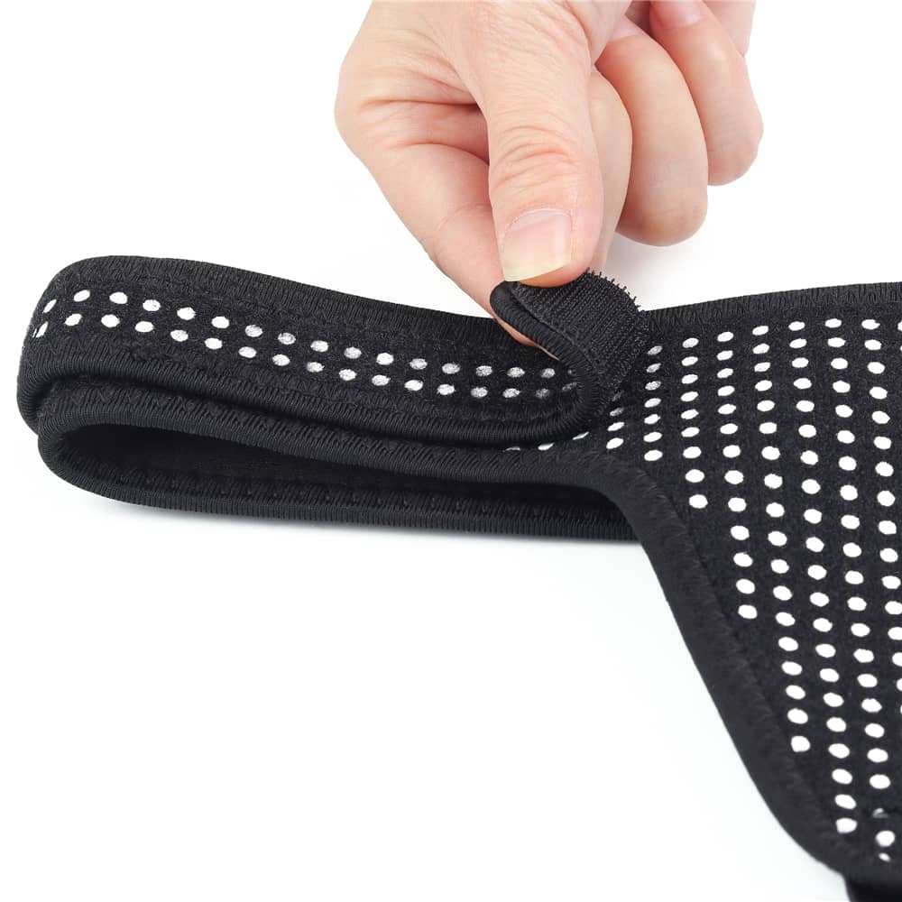 A person holds the adjustable Velcro of the polka dots easy strap on harness