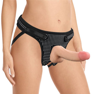 A woman wears the polka dots easy strap on harness with a dildo