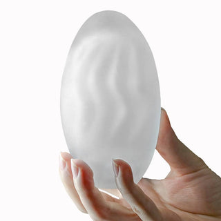 A man holds the giant egg climax spirals masturbator