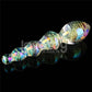 The twilight gleam glass orbs dildo with a luminous rainbow surface lays flat