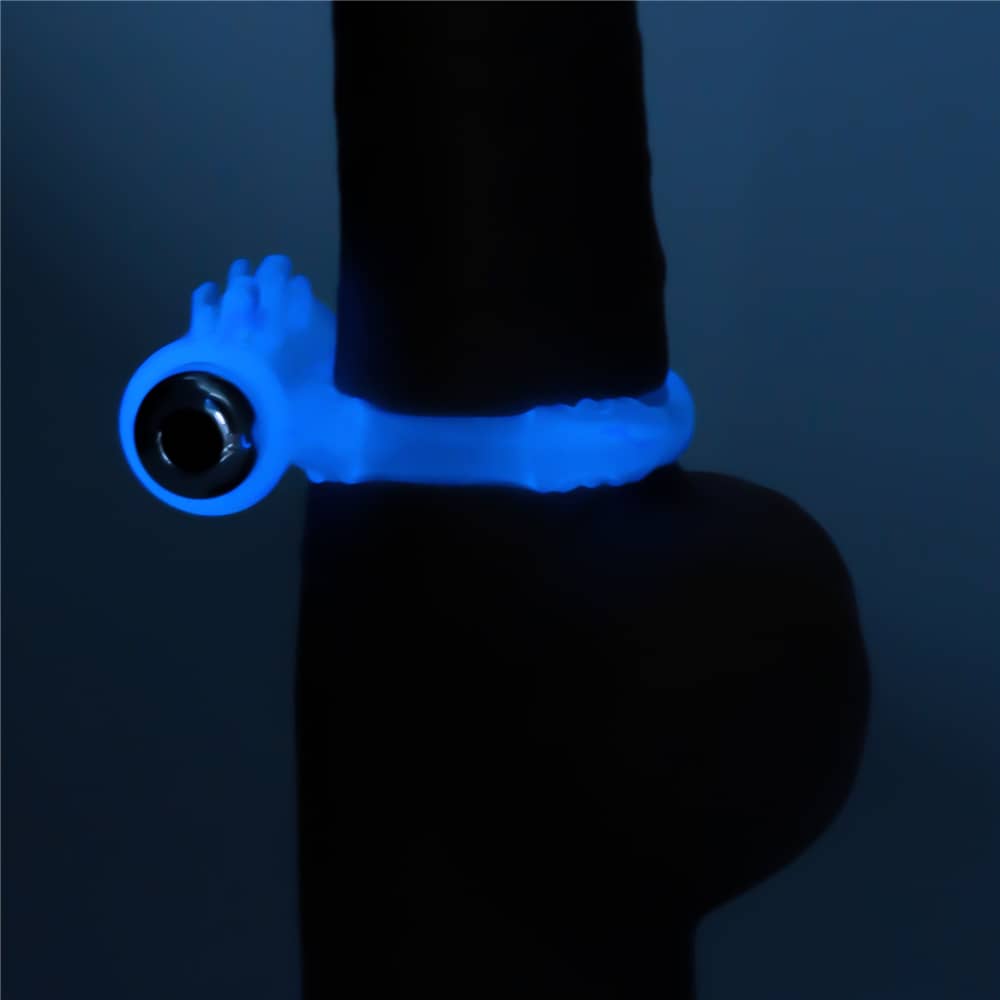 The lumino play vibrating cock ring worn on dildo glowing the blue light in the dark 