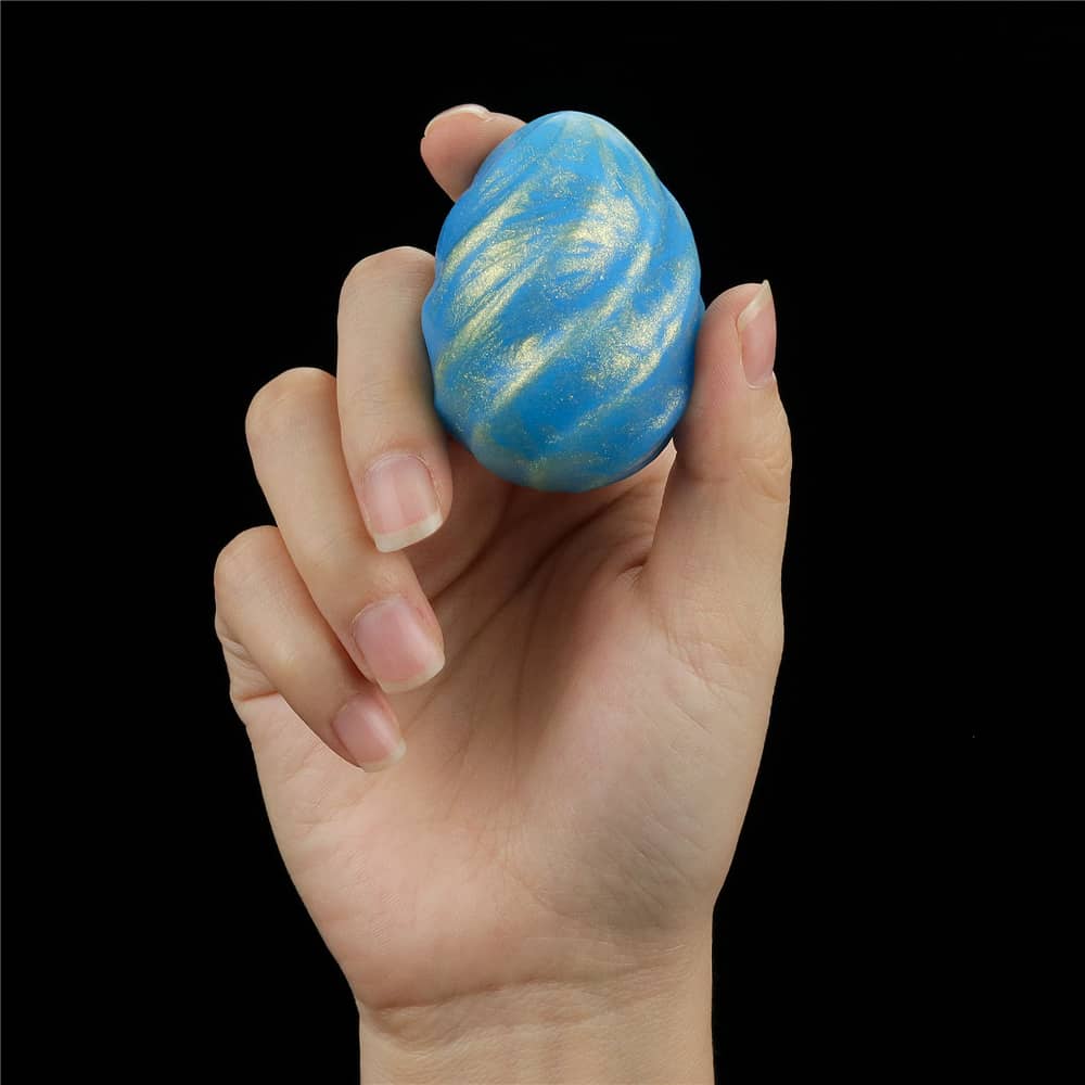 A man holds the bumpy ball of the oceans toner egg set