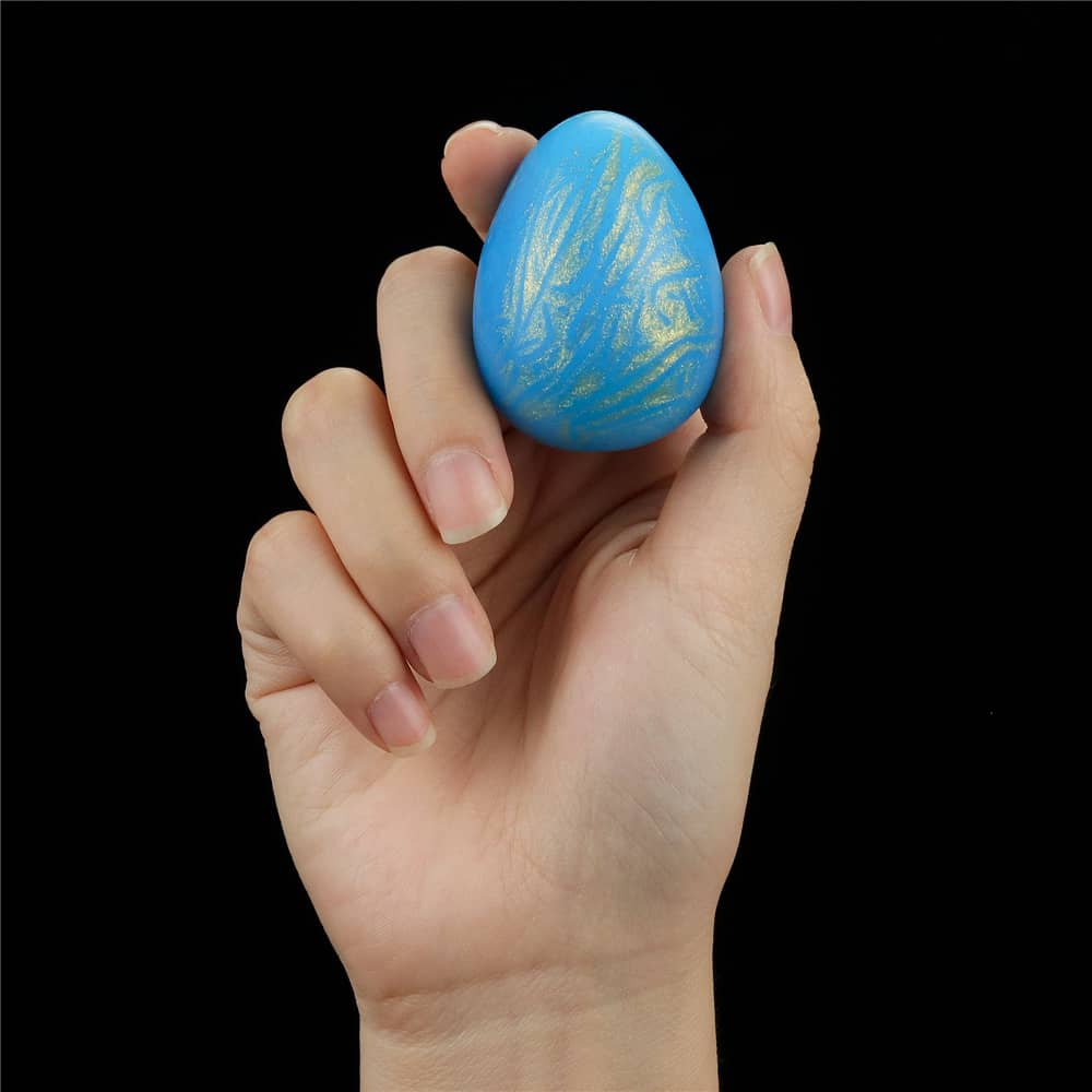 A man holds the smoothly textured ball of the oceans toner egg set