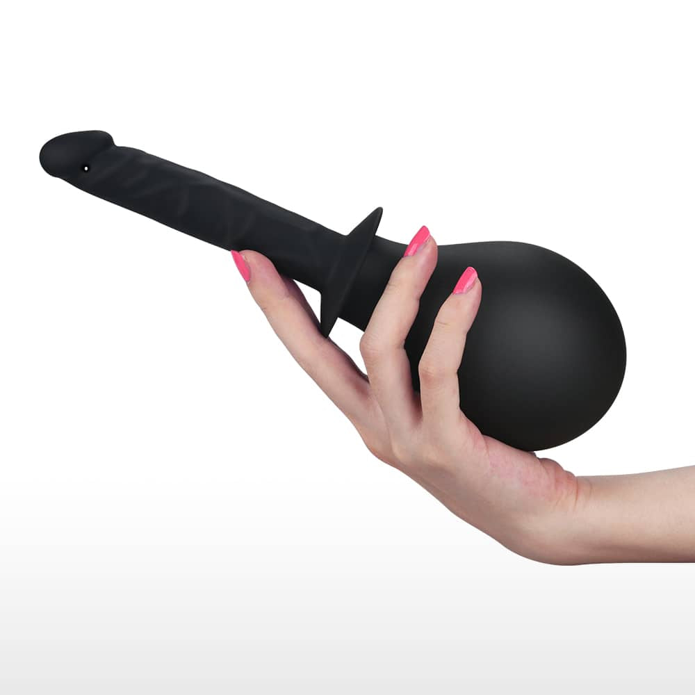 A woman holds the silicone soft deluxe anal douche