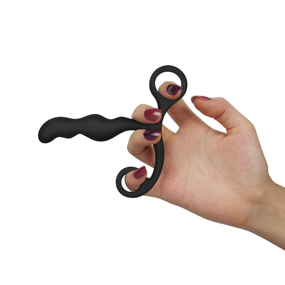 A woman put her finger through the loop of the black silicone p spot teaser 