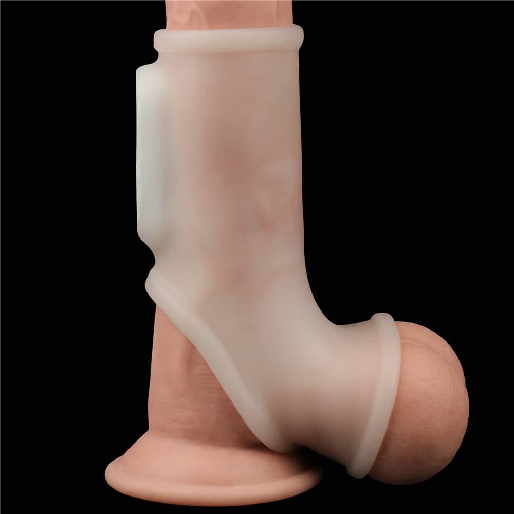  The white  vibrating silk cock ring with scrotum sleeve worn on the upright dildo