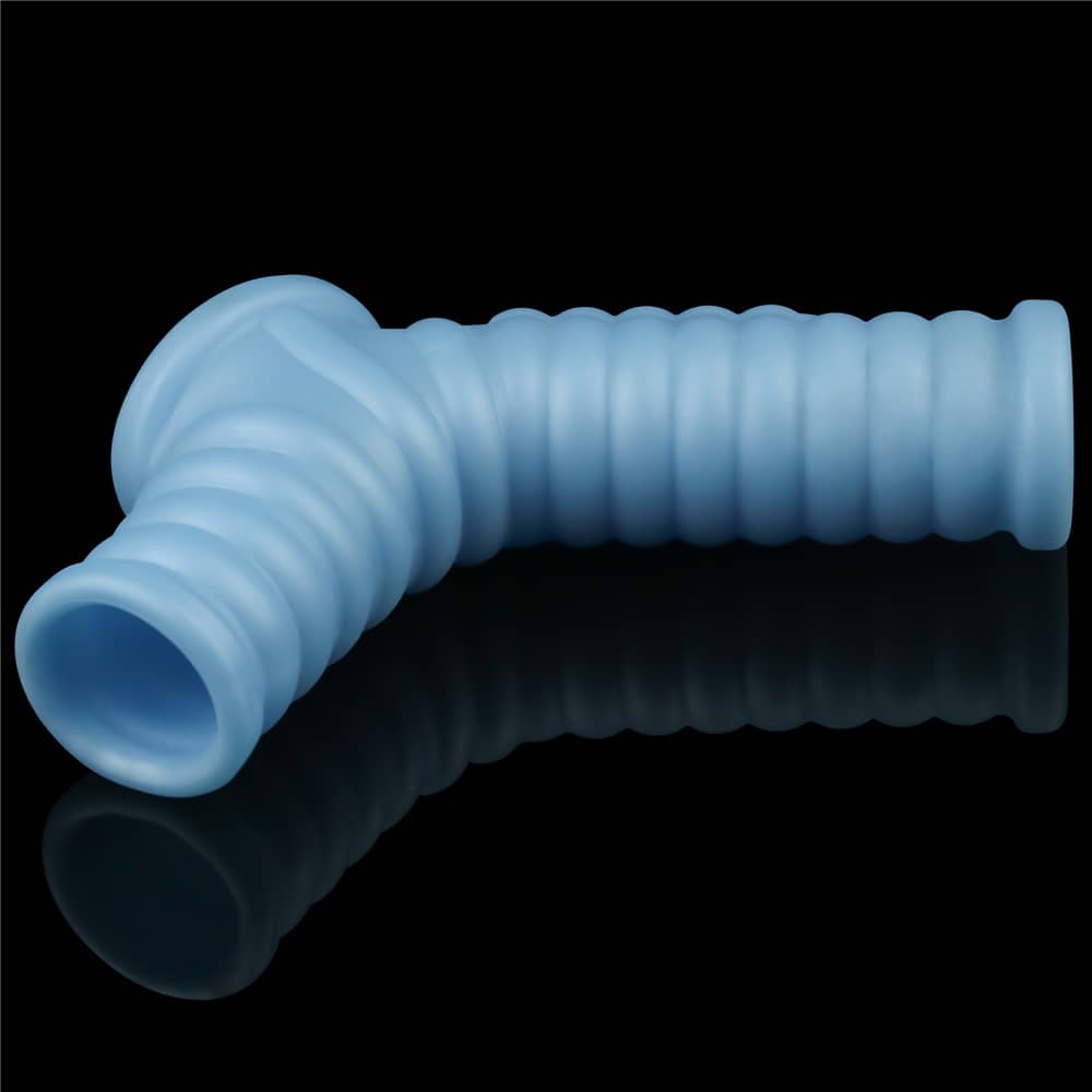 The blue vibrating wave cock ring with scrotum sleeve lays flat
