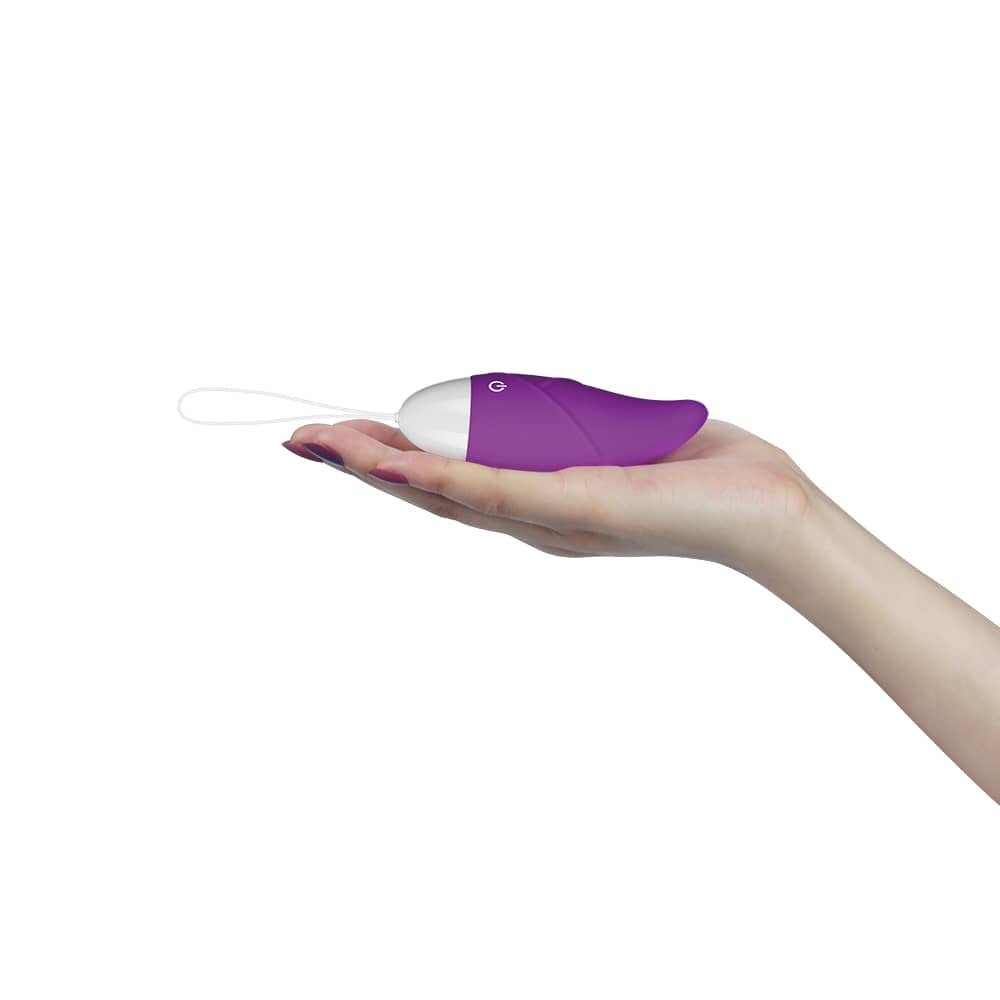 The purple wireless remote control vibrator for women lays flat on the palm