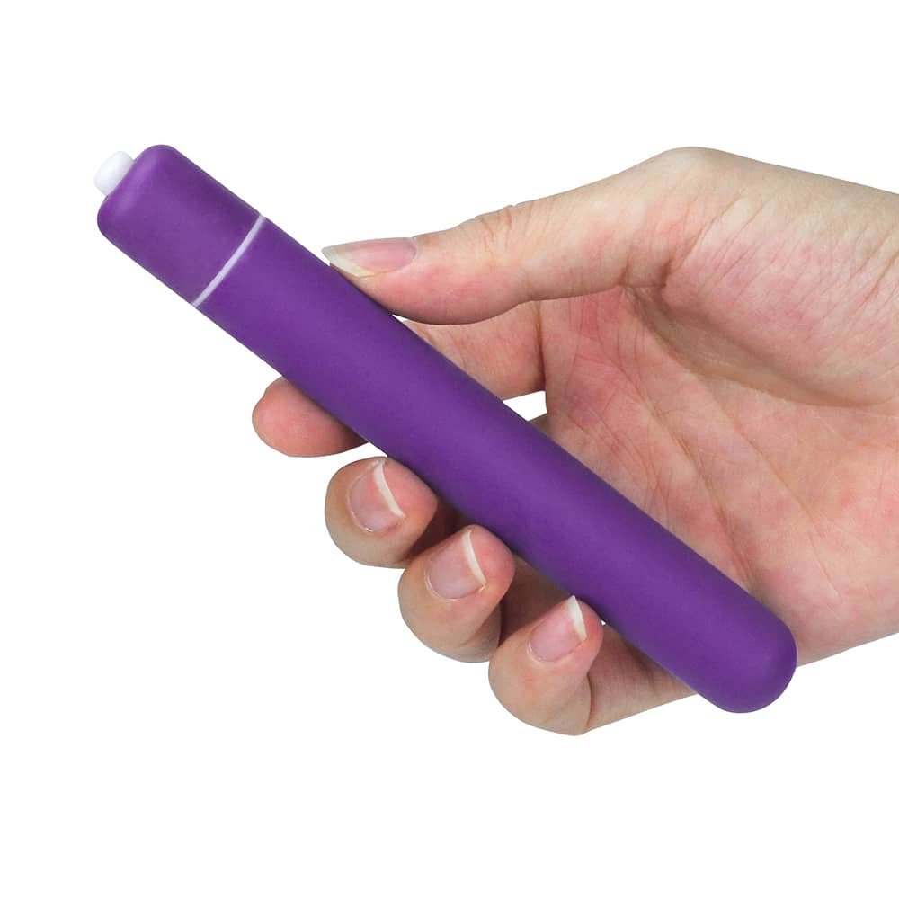 A man holds the purple x-basic bullet 10 speeds vibrator