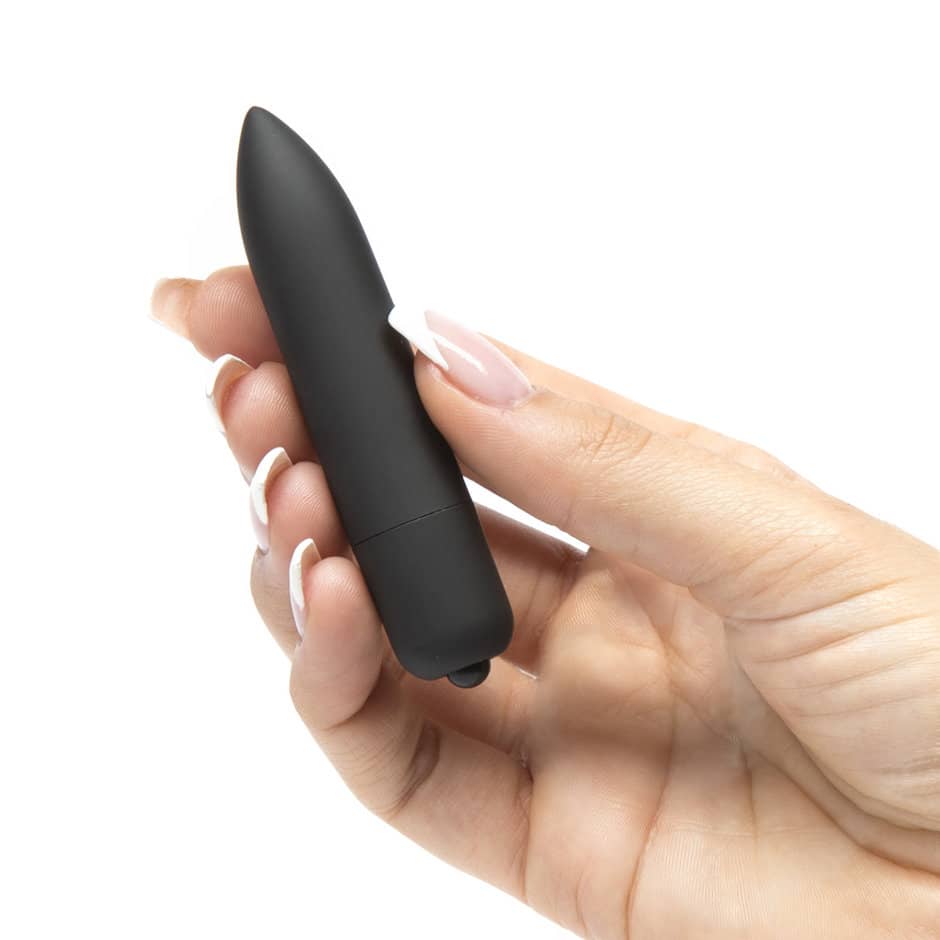 A woman holds the 10 speeds basic long bullet vibrator