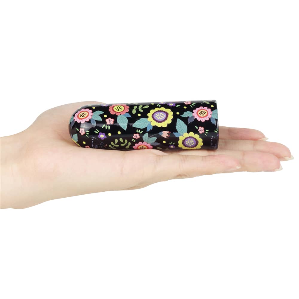 The mini bullet vibrator rechargeable massager lay flat on a womans hand